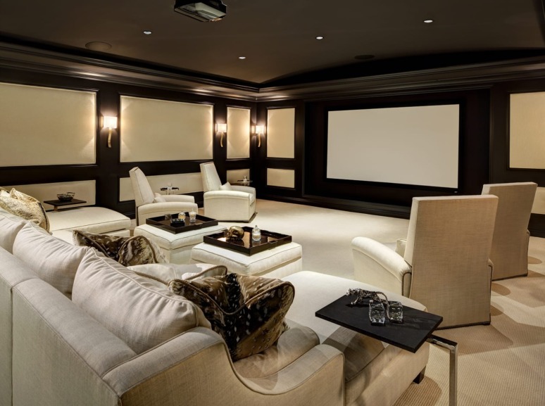 Luxury home theater with plush seating, black and beige decor, large screen, and ambient wall lighting.