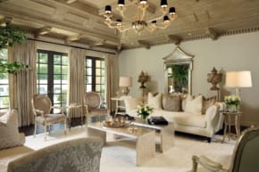 Elegant living room with vintage decor, chandelier, plush seating, large windows, and ornate ceiling in a traditional style.