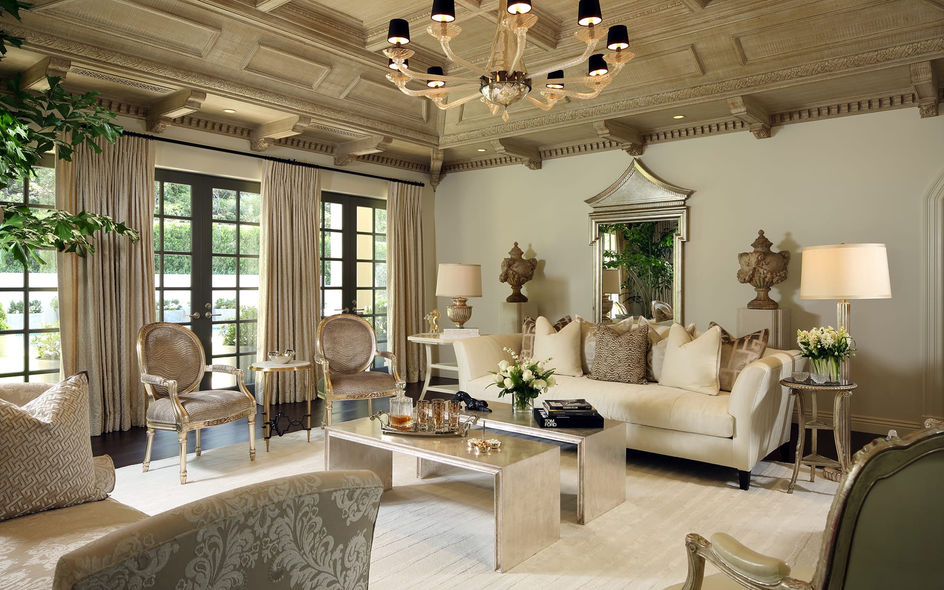 Elegant living room with vintage decor, chandelier, plush seating, large windows, and ornate ceiling in a traditional style.