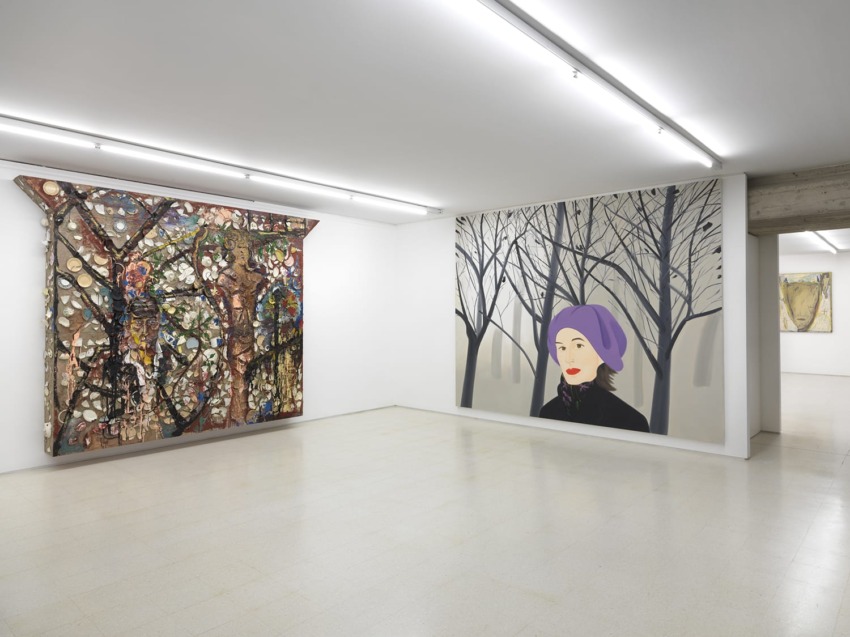 Art gallery interior with colorful abstract paintings on white walls, featuring a portrait of a woman in a purple beret.