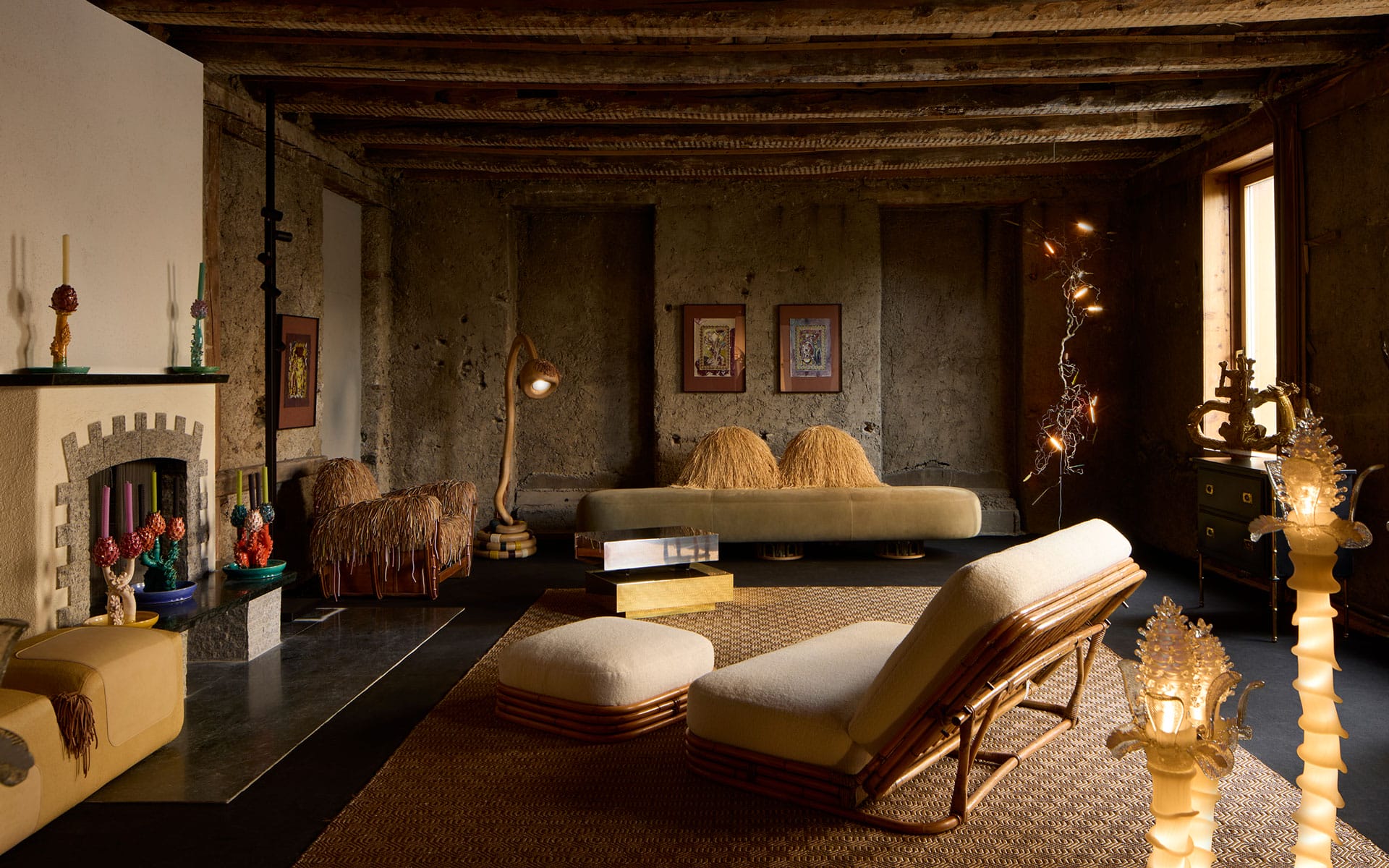 Cozy living room with vintage furniture, woven rugs, and a rustic wooden ceiling, lit by warm ambient lighting.