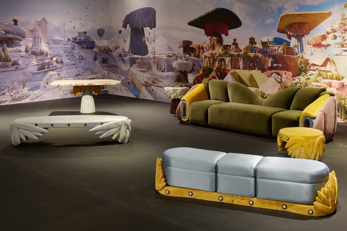 Colorful, surreal furniture set with sofa, tables, and bench on display in a whimsically themed room.
