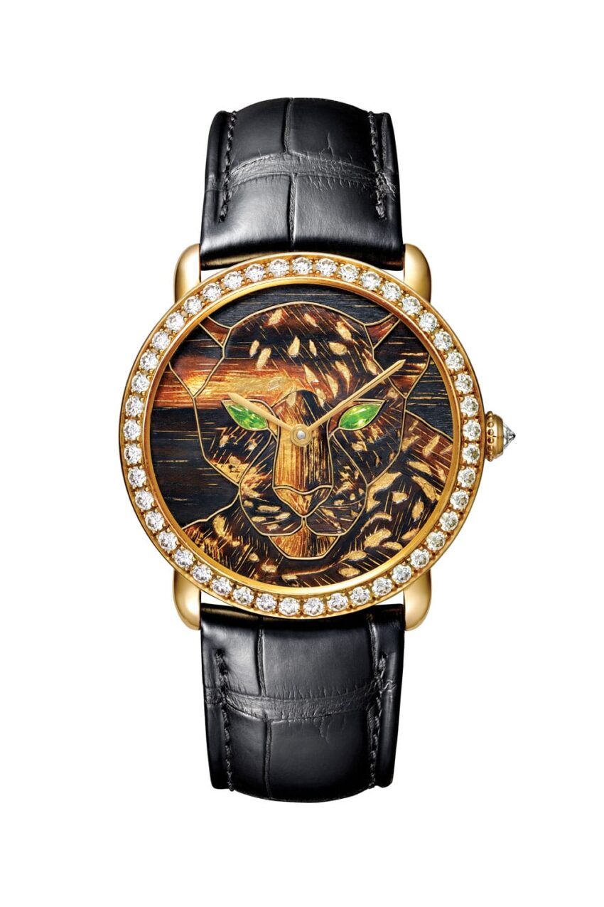 Luxury watch with a panther design on the dial, diamond-studded gold bezel, and black leather strap.