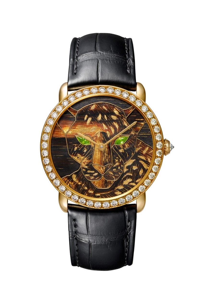 Luxury watch with a panther face design, diamond-encrusted gold bezel, green eyes, and black leather strap.