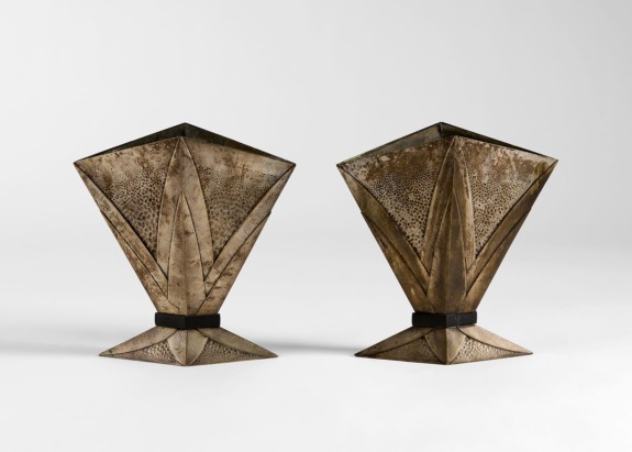 Two vintage, geometric metal sculptures with a textured, bronze-like finish displayed on a plain background.