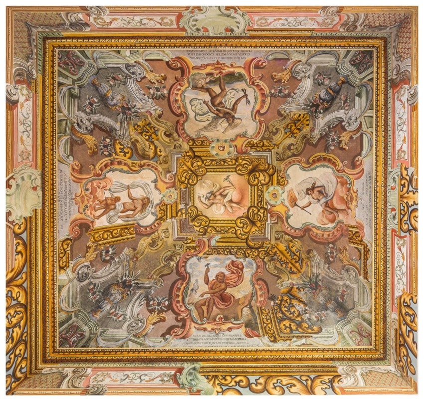 Ornate ceiling mural featuring mythological scenes and detailed Baroque-style artwork in rich colors and intricate designs.