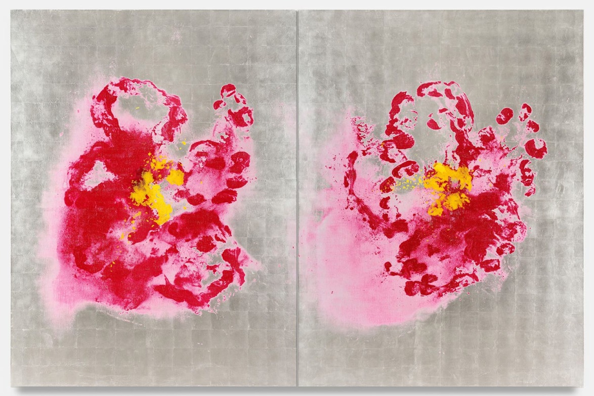 Abstract artwork with red and yellow splatters on a gray background, resembling two floral shapes side by side.