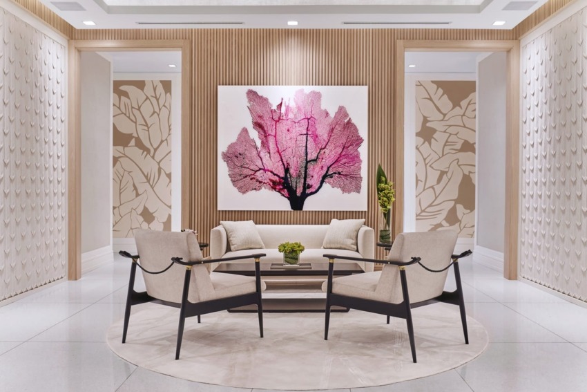 Modern lobby with four beige chairs, a small table, and a large pink abstract artwork on a wooden accent wall.