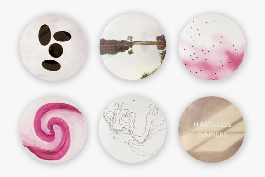 Set of six artistic ceramic plates with various abstract designs and patterns, including swirls, dots, and landscapes.