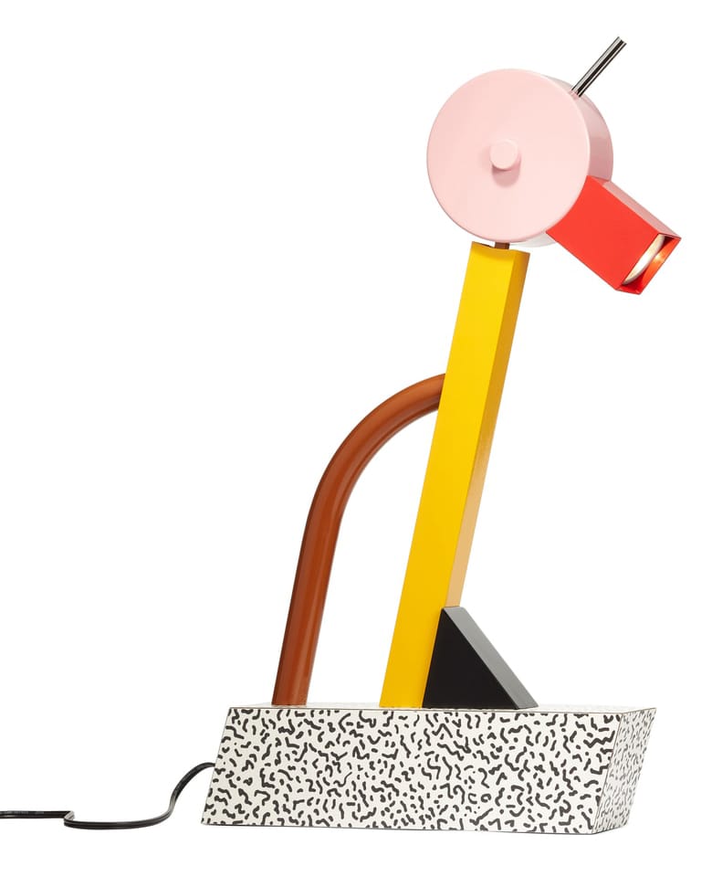 Colorful, geometric table lamp with a patterned base, featuring bold red, pink, yellow, and brown elements.