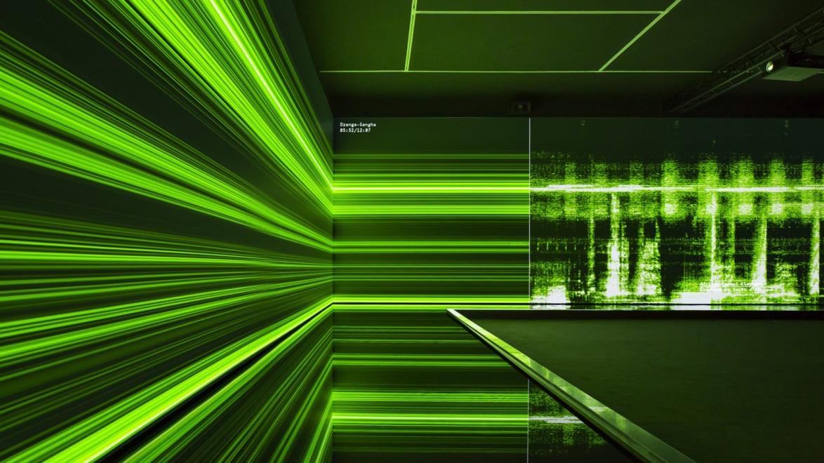 Abstract digital art with green horizontal and vertical lines creating a futuristic, immersive environment in a dark room.