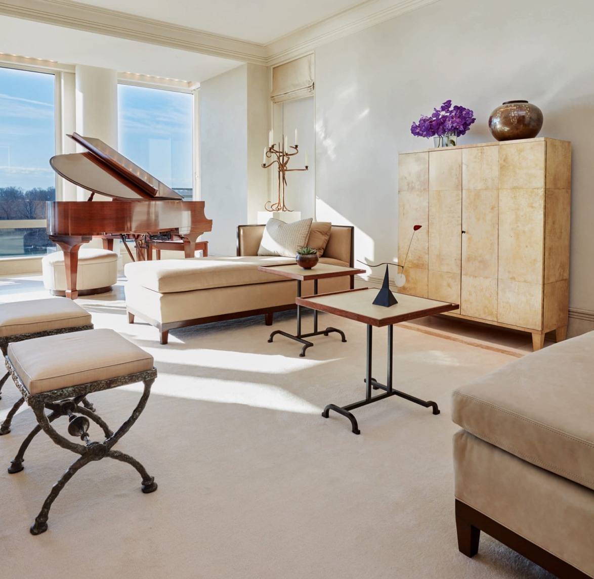 spacious living room with a grand piano, modern furniture, bright natural light, and minimalist decor