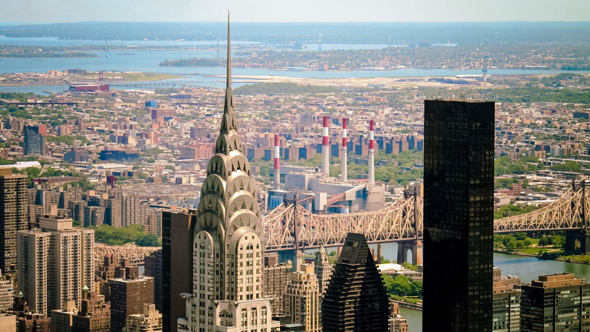 Aerial view of the Chrysler Building and Queensboro Bridge in New York City with skyline and river in the background