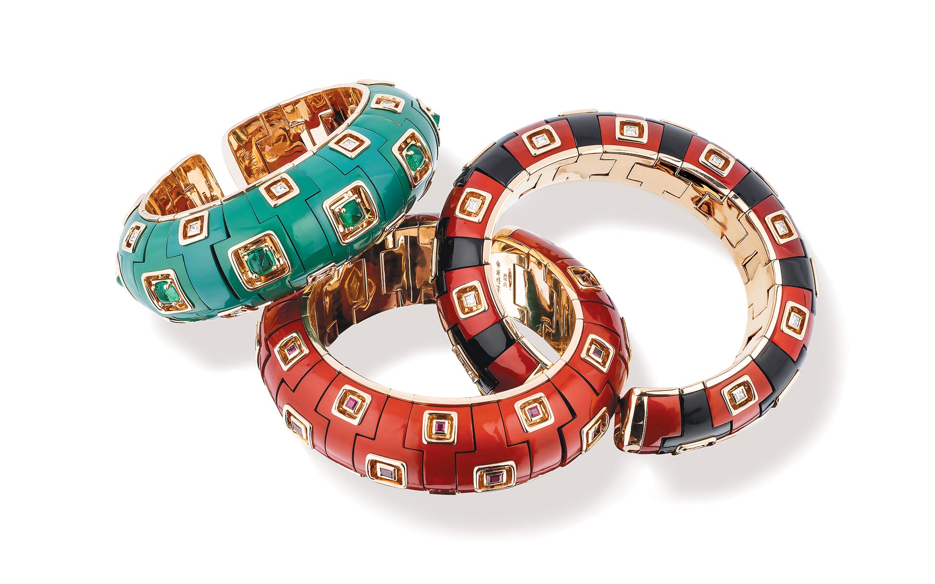 Three colorful, linked bracelets featuring turquoise, red, and black designs with gold accents and square embellishments.