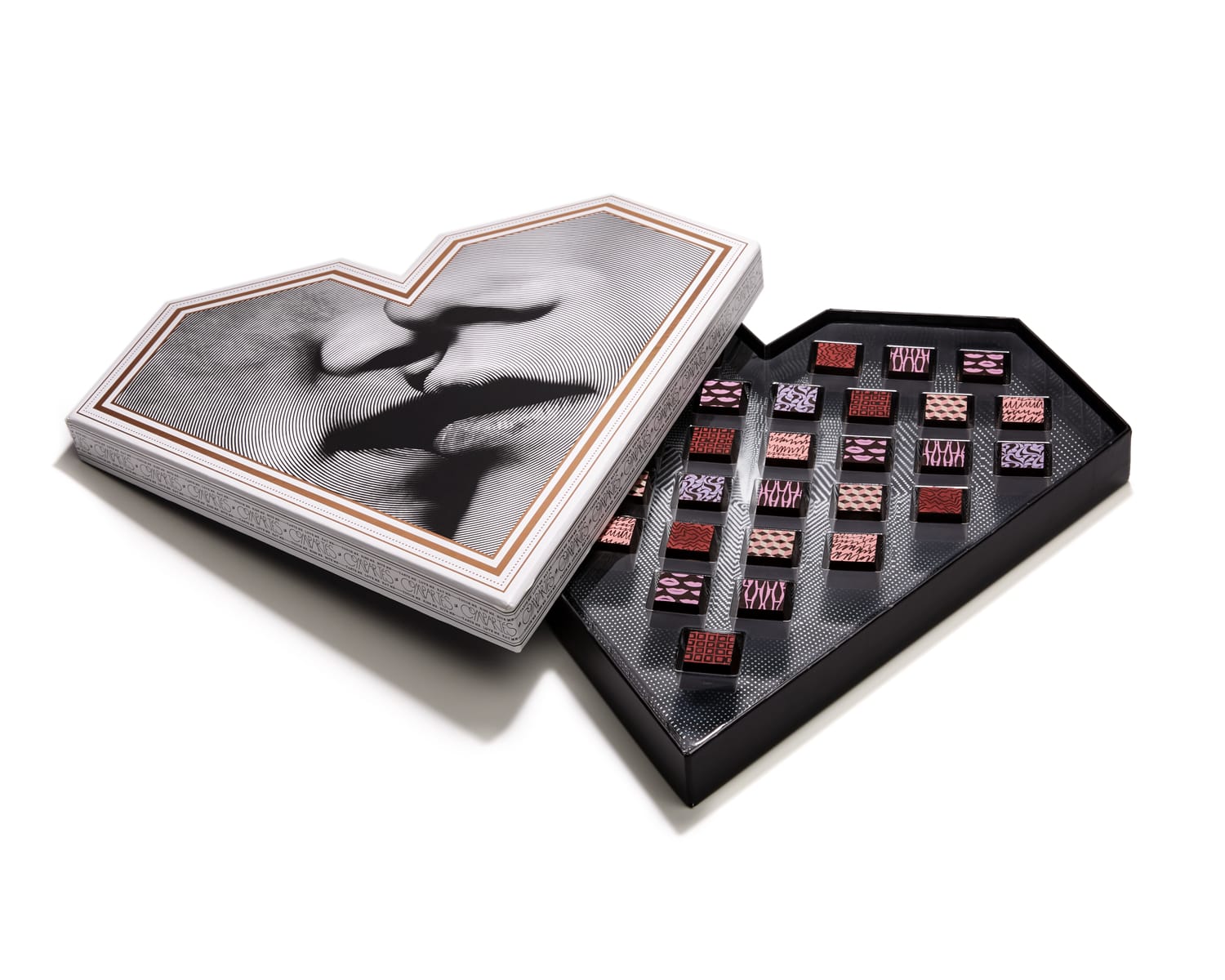Heart-shaped box of assorted chocolates with a monochrome image of two faces on the lid.