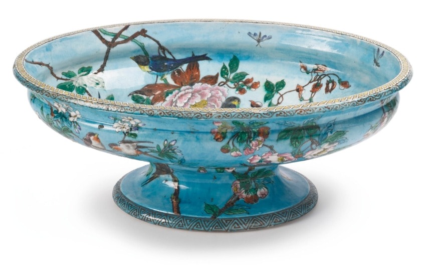 Blue ceramic bowl with floral and bird patterns, featuring intricate designs and a round base.