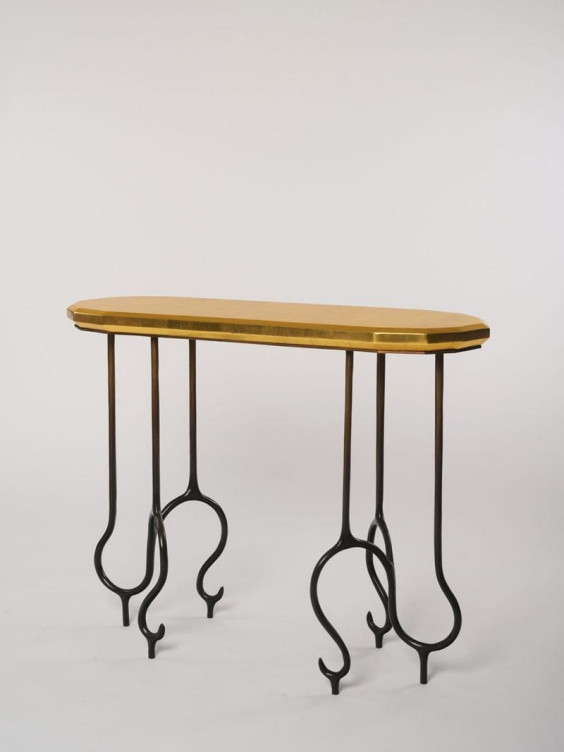 Wooden console table with a slim oval top and elegant curved metal legs against a plain background.