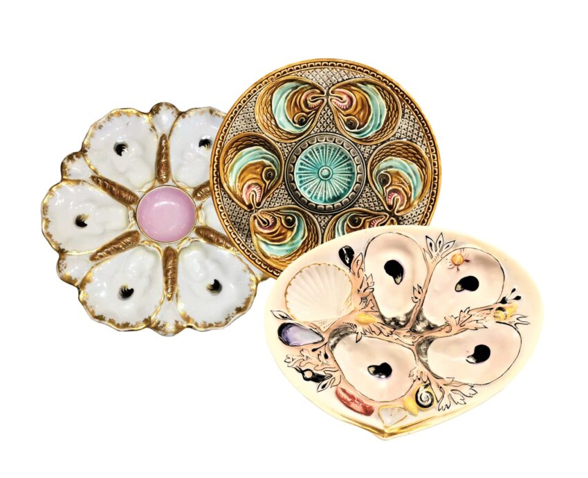 Three vintage decorative plates with ornate designs and pastel colors arranged on a white background.