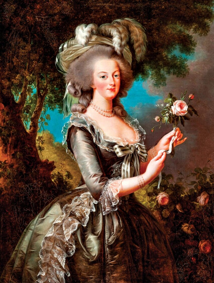 Woman in 18th-century attire with a large hat and feather, holding a rose, standing against a lush, wooded backdrop.
