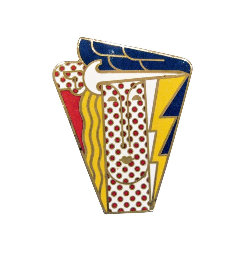 Abstract enamel pin with colorful design elements, including red dots, yellow shapes, and blue accents.