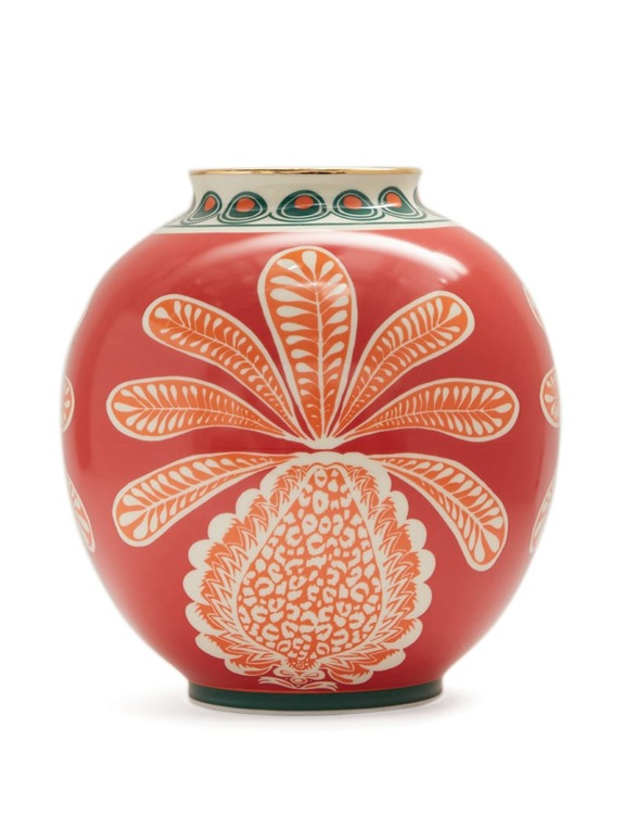 Red and white ceramic vase with intricate floral patterns and green accents on the rim.