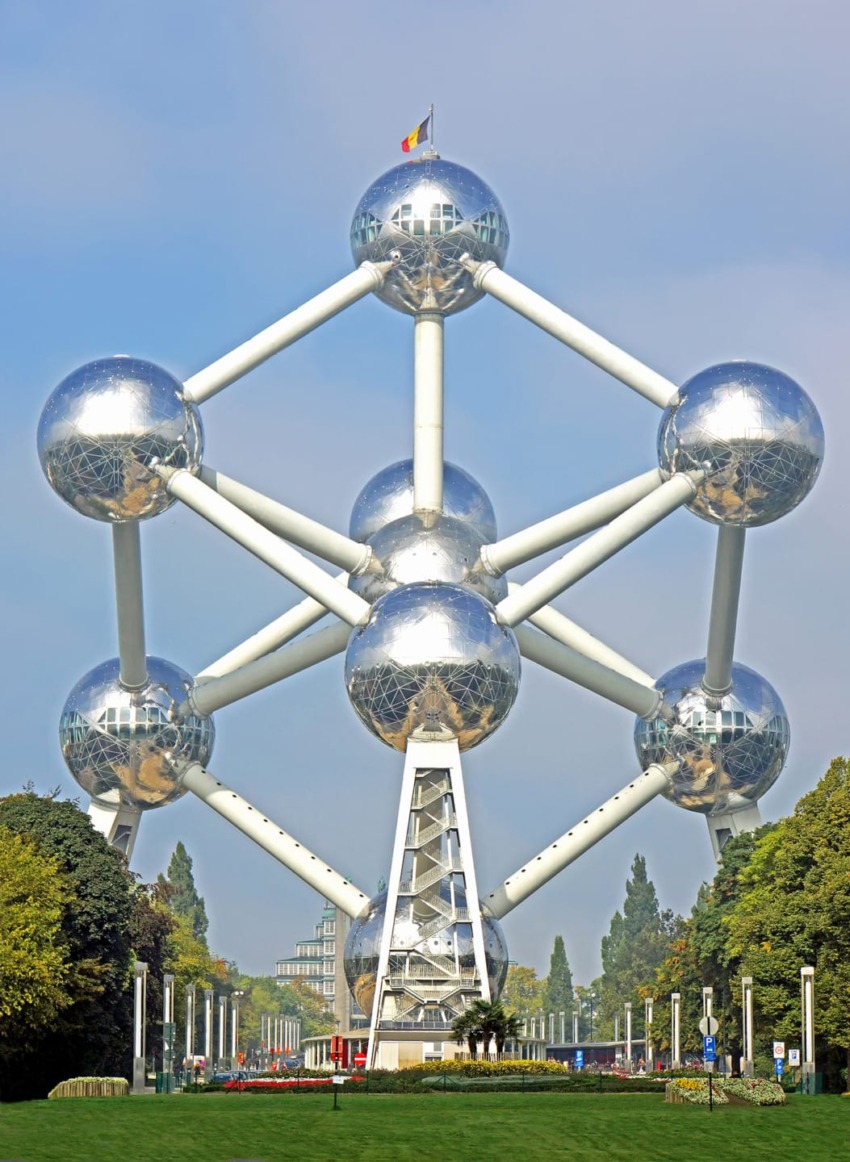 Atomium in Brussels, a steel structure shaped like an iron atom, with spheres connected by tubes, flag on top.