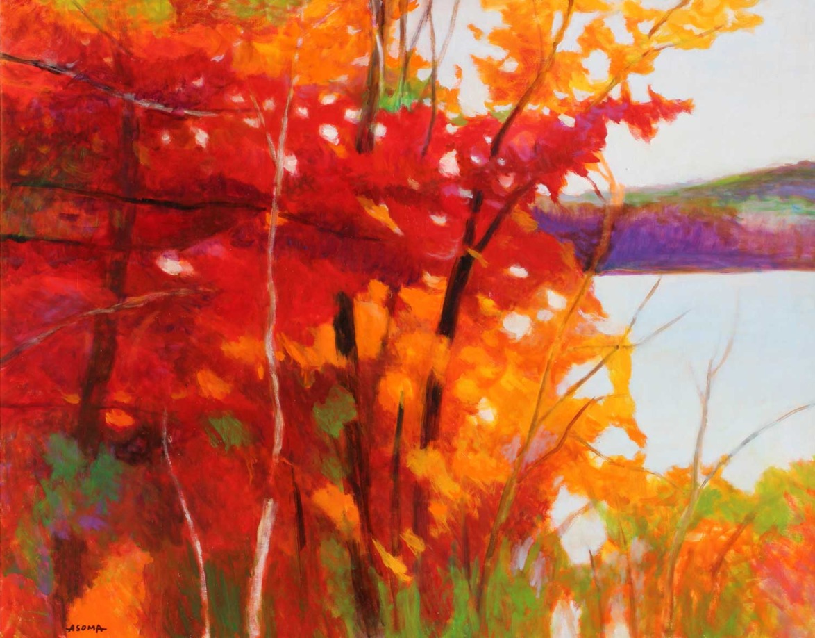 Vibrant autumn landscape with red and orange trees by a lake, capturing the essence of fall foliage.