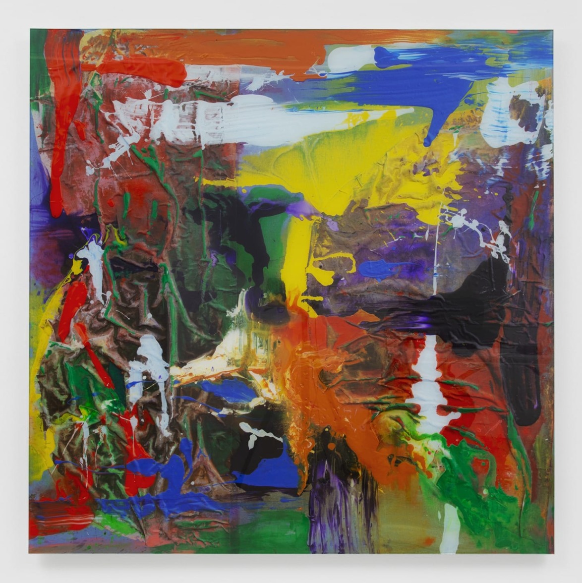 Abstract painting with vibrant splashes of red, blue, yellow, and green on a white background.