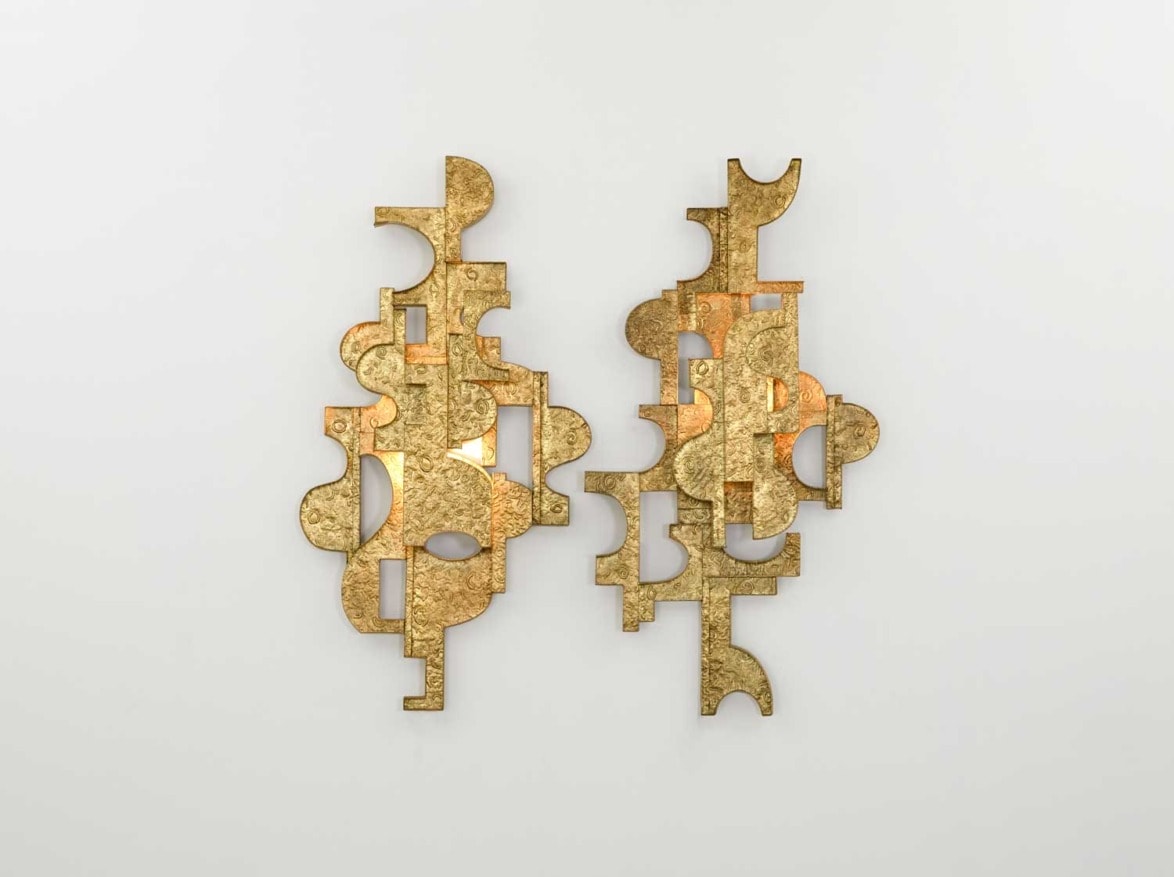 Abstract gold wall sculptures with geometric shapes on a white background.