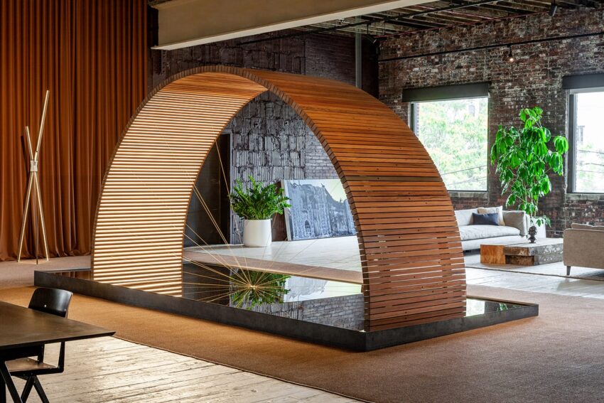 Modern interior with a wooden arched structure, indoor plants, and a cozy seating area in a spacious loft setting.