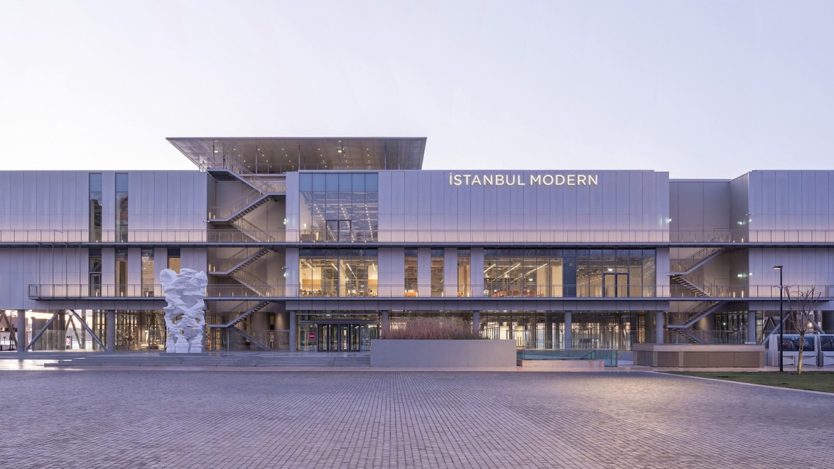 Exterior view of Istanbul Modern Museum with a large sculpture in front, showcasing contemporary architectural design.