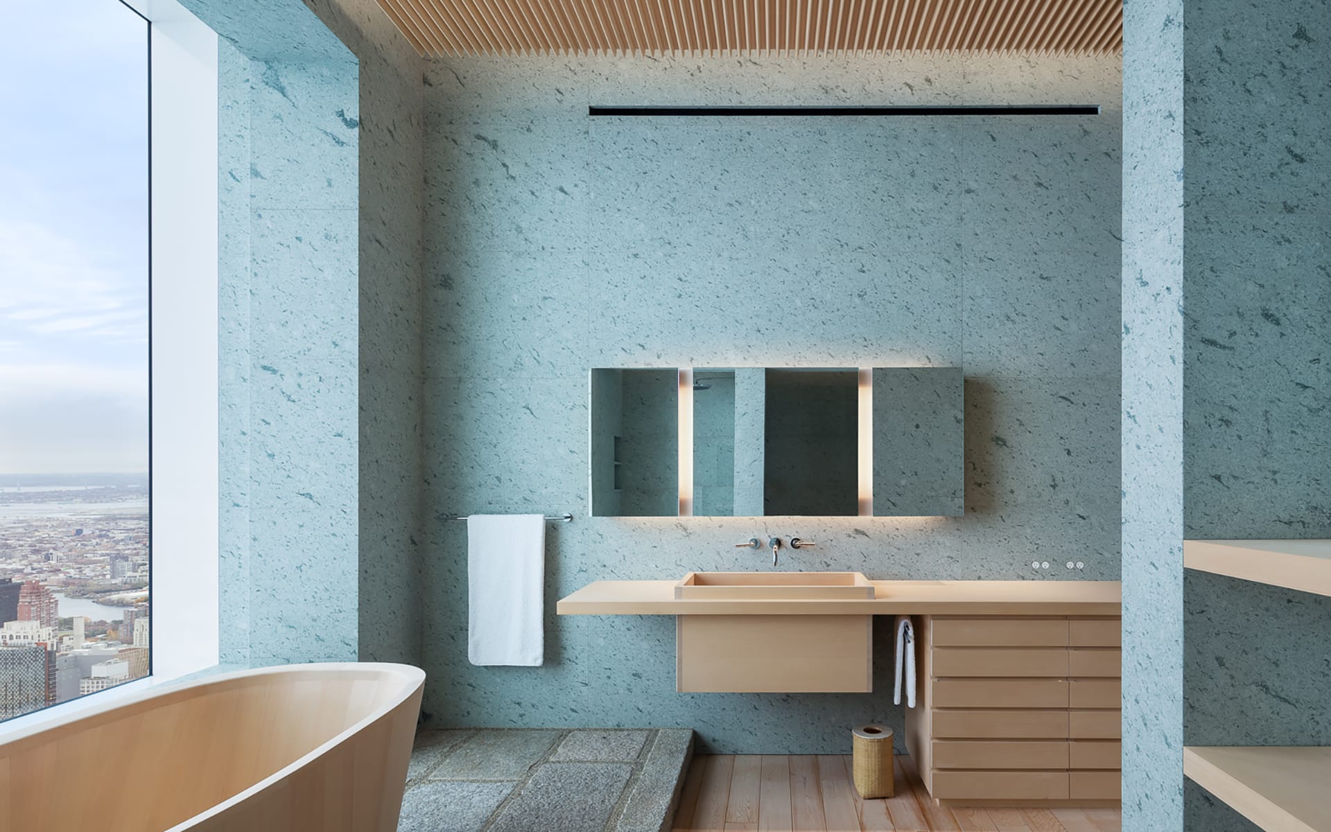 Modern bathroom with large window view, light wood fixtures, and a freestanding tub in a minimalistic design.