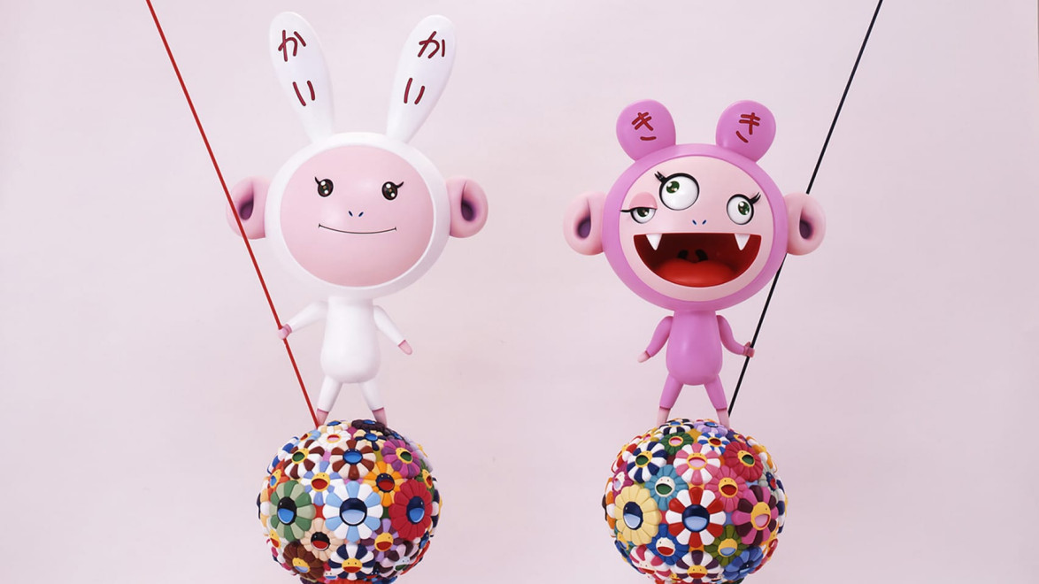 Two colorful cartoon figures standing on floral patterned spheres with playful expressions and antennas against a plain background.