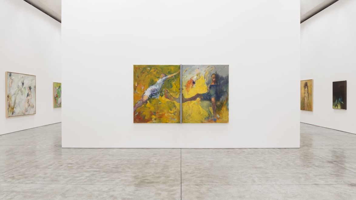 Art gallery interior with large paintings on white walls and a polished concrete floor.