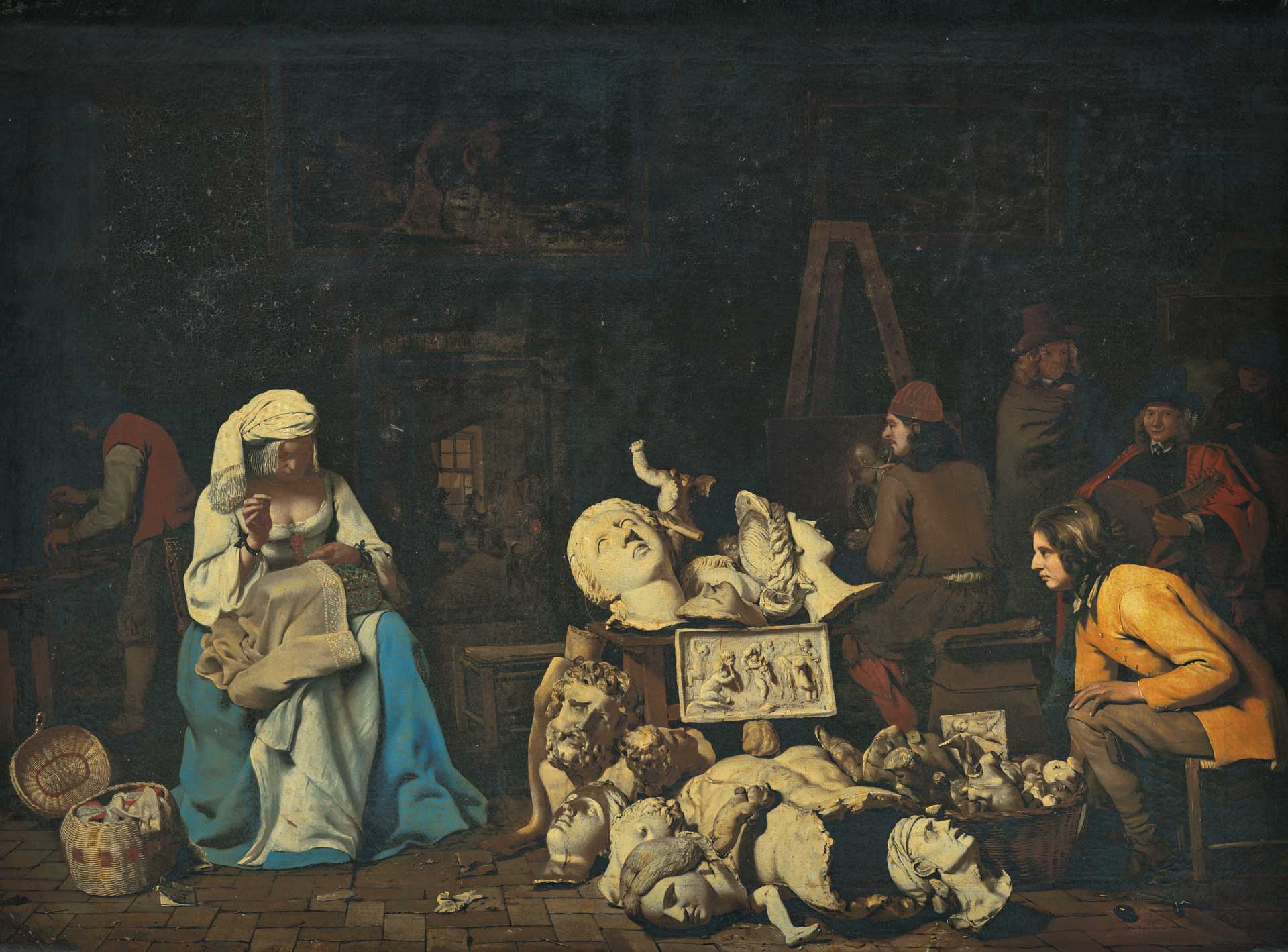 A woman sewing next to classical sculptures, with artists in a dimly lit studio, creating a lively art scene.