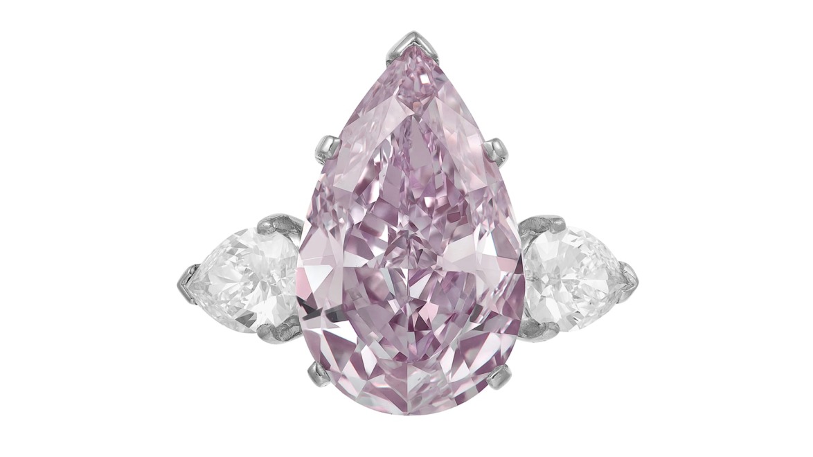 Pear-shaped pink diamond ring with two smaller round diamonds on a white background.