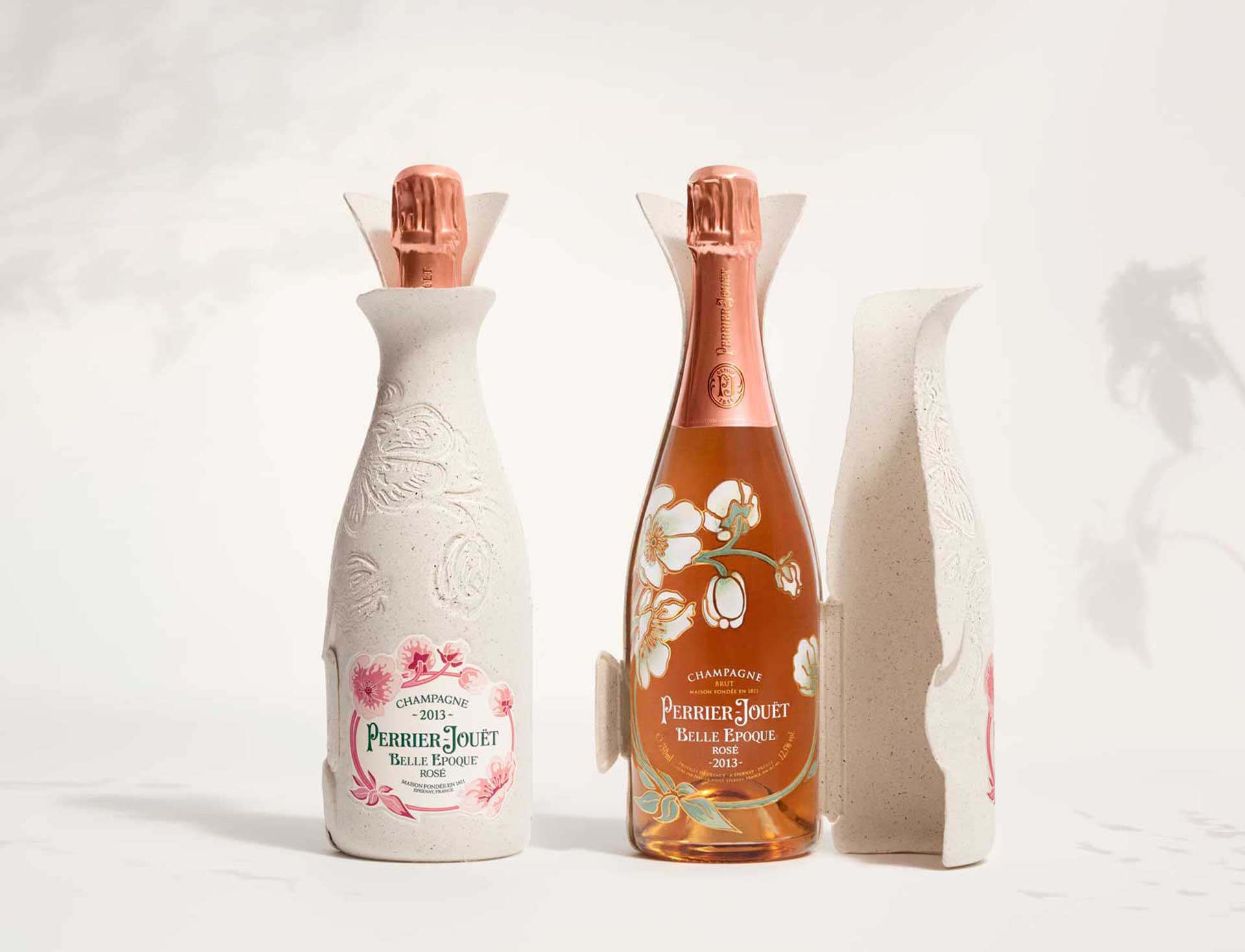 Perrier-Jouët Belle Epoque champagne bottles, one with floral design and another in decorative packaging.