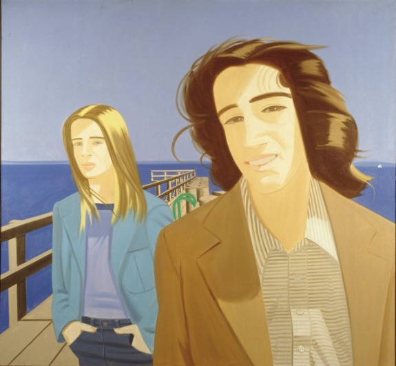 Two people standing on a pier with a clear blue sky in the background.