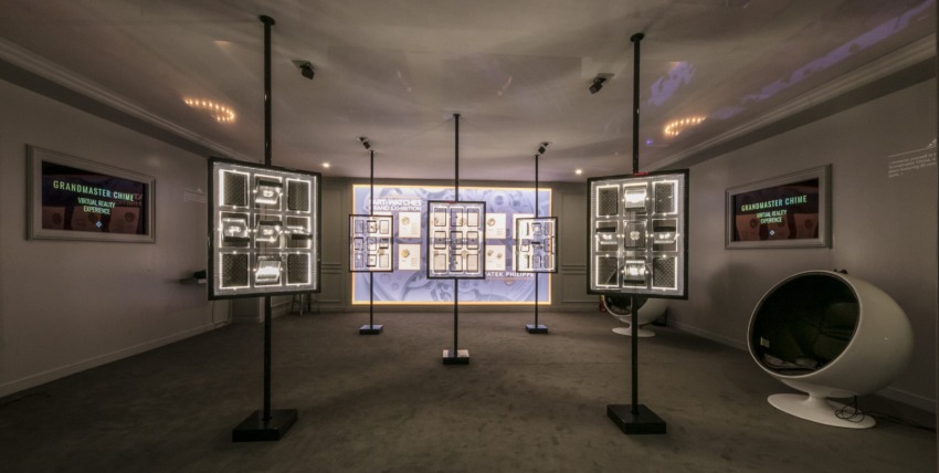 Modern exhibition room with freestanding light panels and information displays on walls, showcasing historical content.