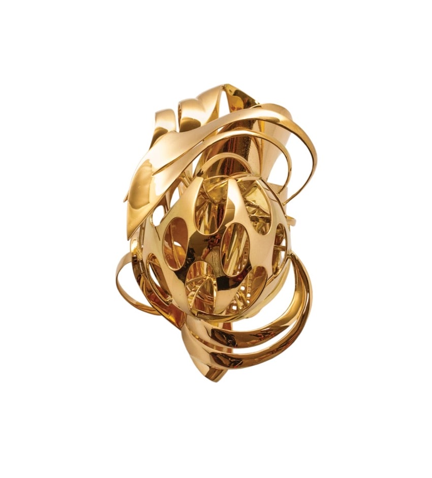 Abstract gold sculpture with swirling, intertwining shapes and a glossy finish, set against a plain white background.