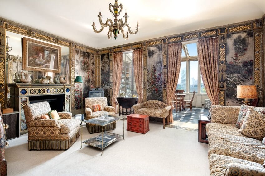 Luxurious living room with ornate wallpaper, plush seating, a chandelier, and large windows overlooking a cityscape.