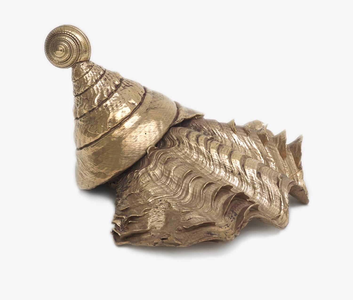 Golden spiral shell sculpture on white background.