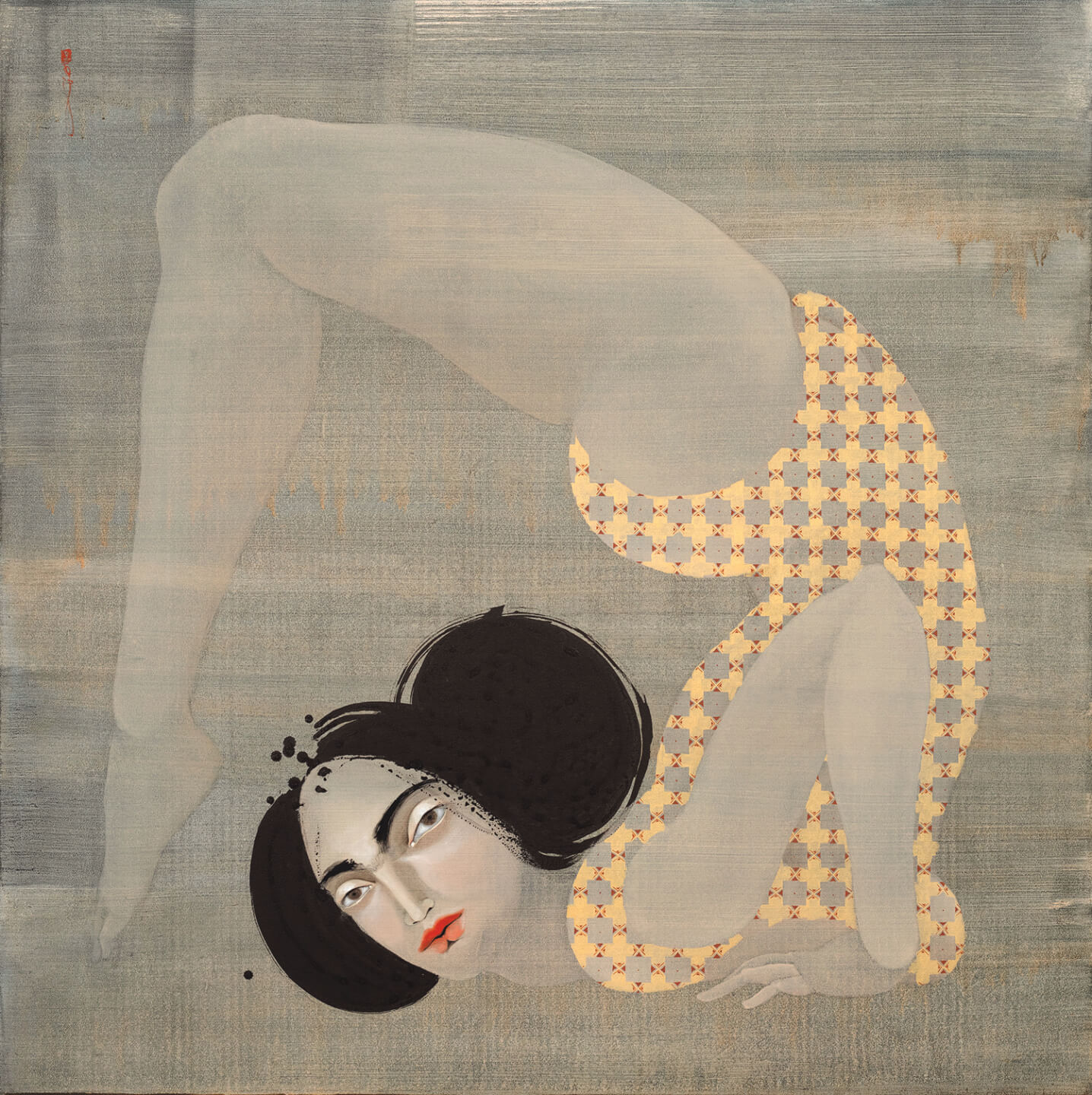 Woman in a yellow patterned leotard performing a contortion pose against a textured blue-gray background.