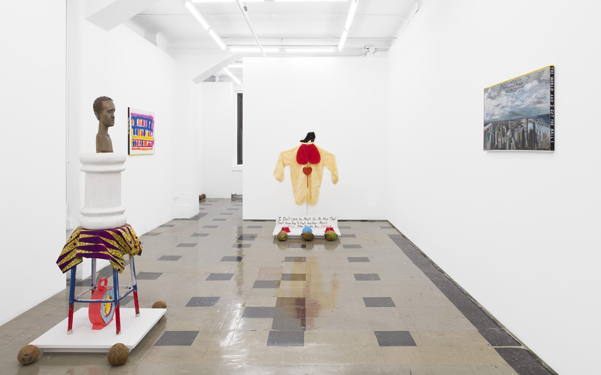 Modern art gallery with sculptures and paintings on walls, featuring a mix of vibrant colors and diverse textures.