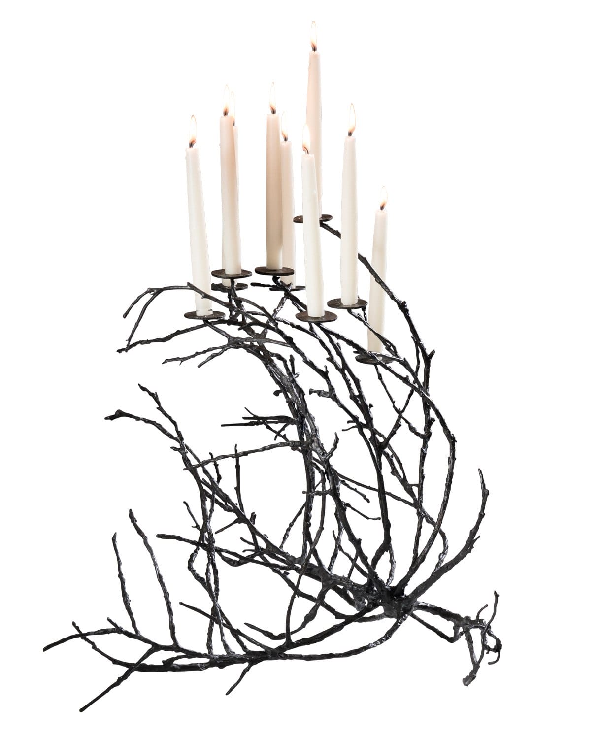 Decorative black branch candle holder with seven lit white candles arranged in an artistic formation.