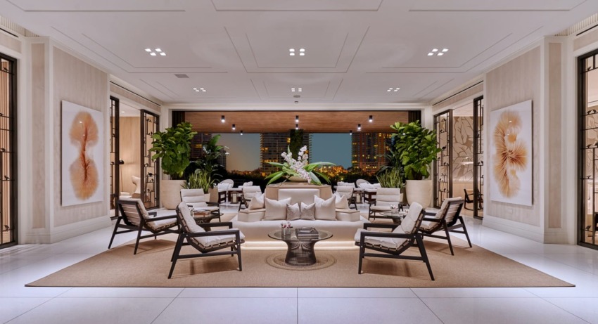 Luxurious hotel lobby with modern seating, elegant decor, large artworks, and panoramic city view through glass walls.