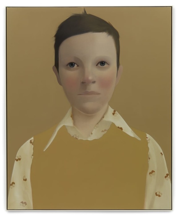 A portrait of a person with a neutral expression, short dark hair, wearing a patterned shirt and mustard-colored vest.