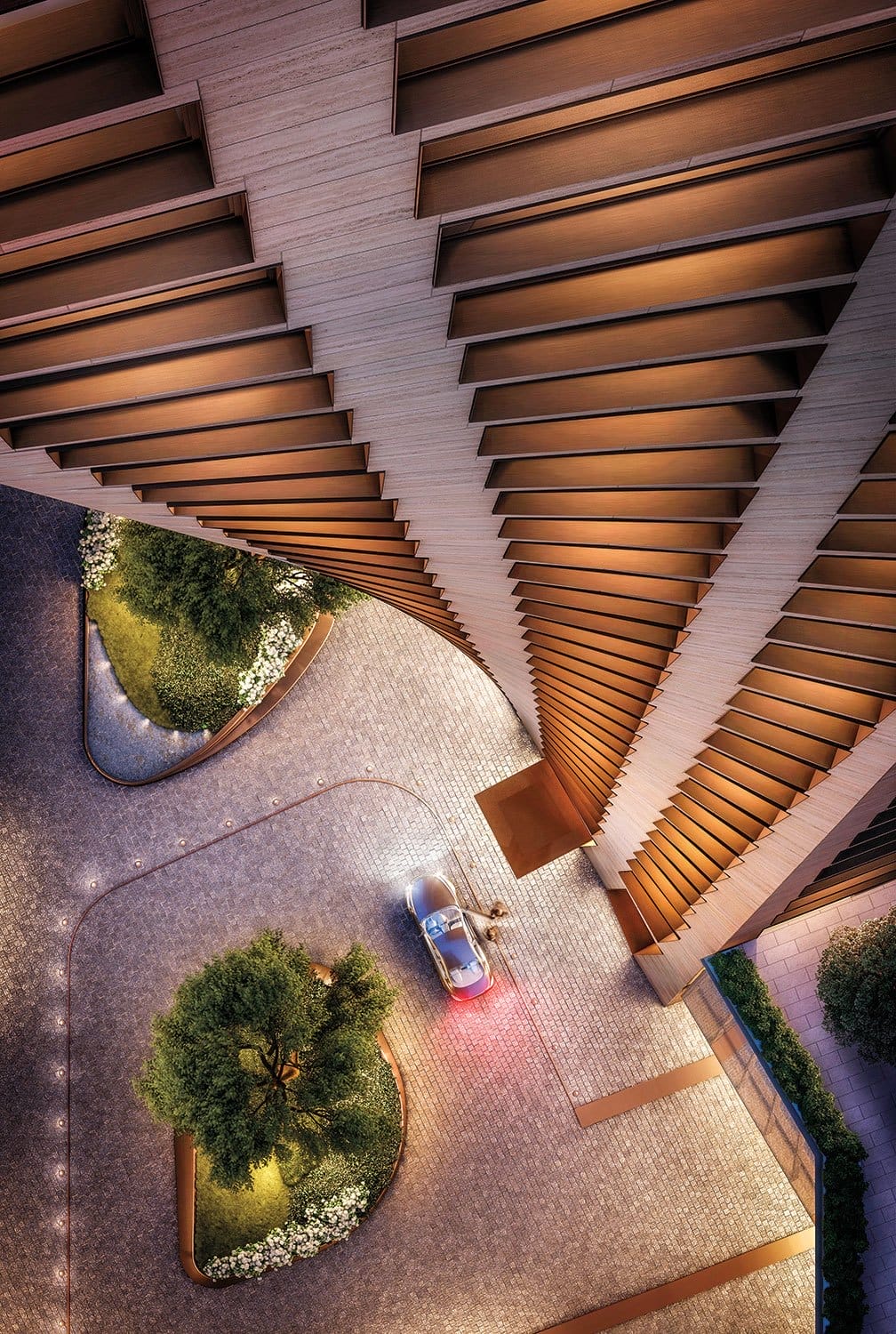 Aerial view of a spiraling modern building with landscaped areas and a car parked near the entrance at dusk.