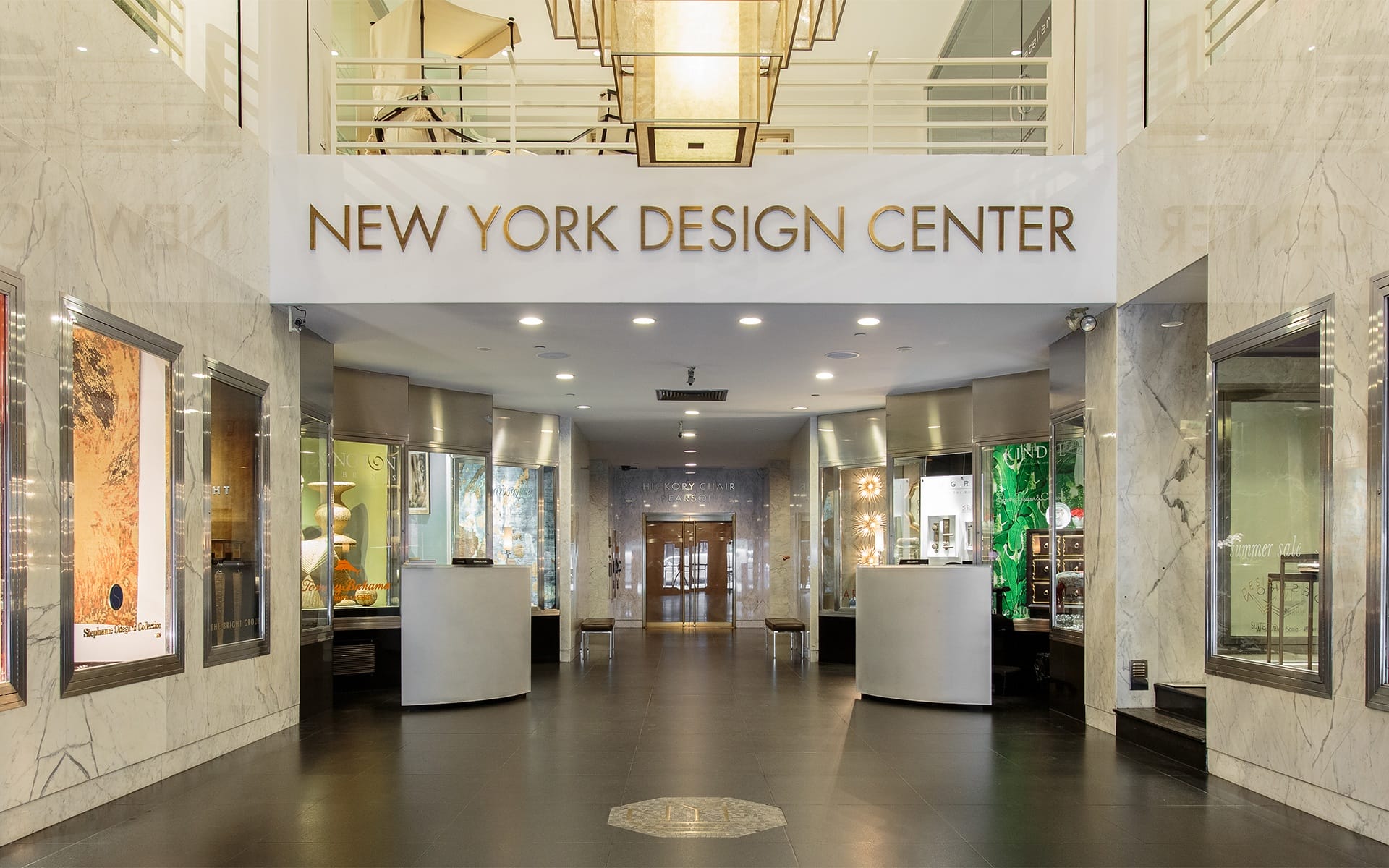 Lobby of New York Design Center with marble walls and decorative lighting.