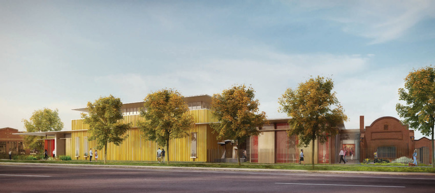 Modern building facade with yellow panels, surrounded by trees and people walking on a sunny day.